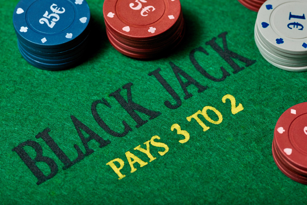 Blackjack table close-up with focus on the payout with chips around the text.